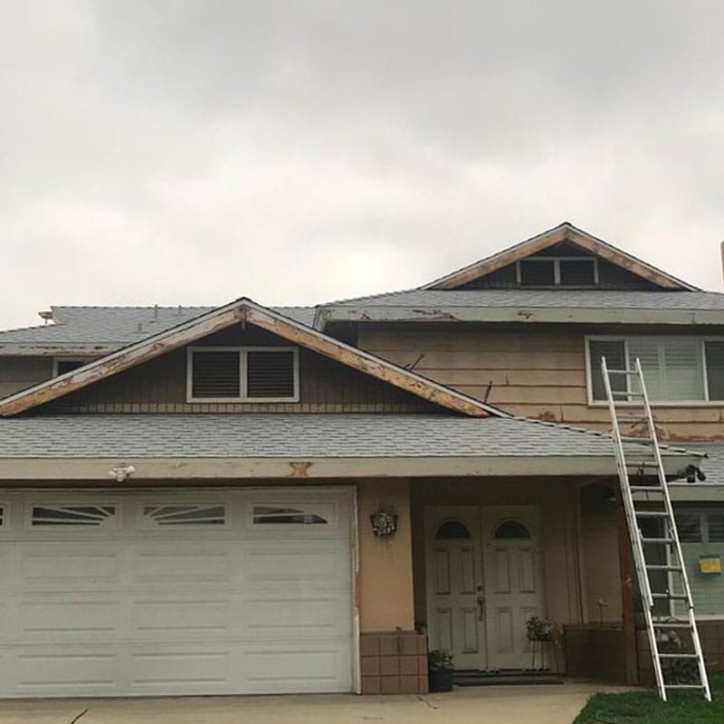 Before image of a Florida house with an old shingle roof and old siding.